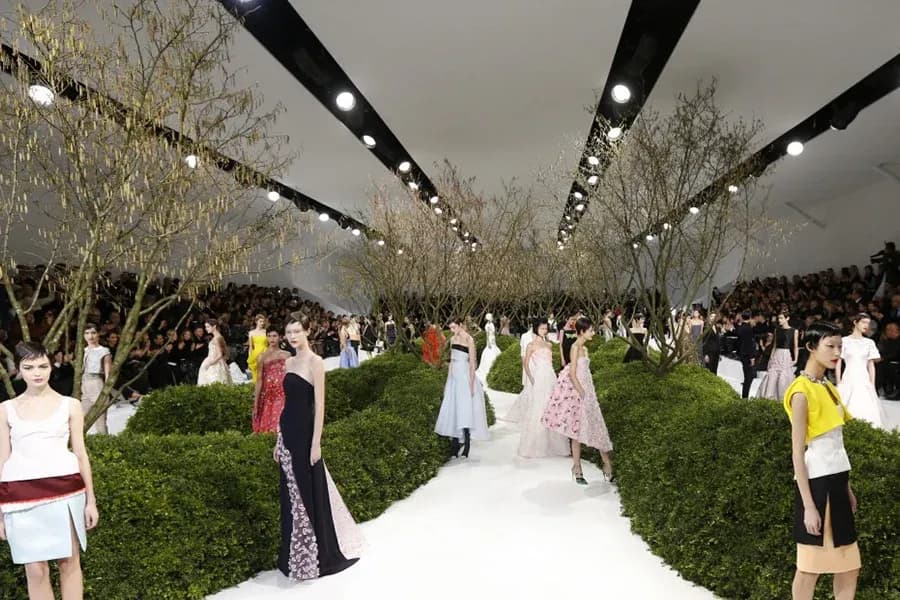 Dior haute couture show models walking through stage